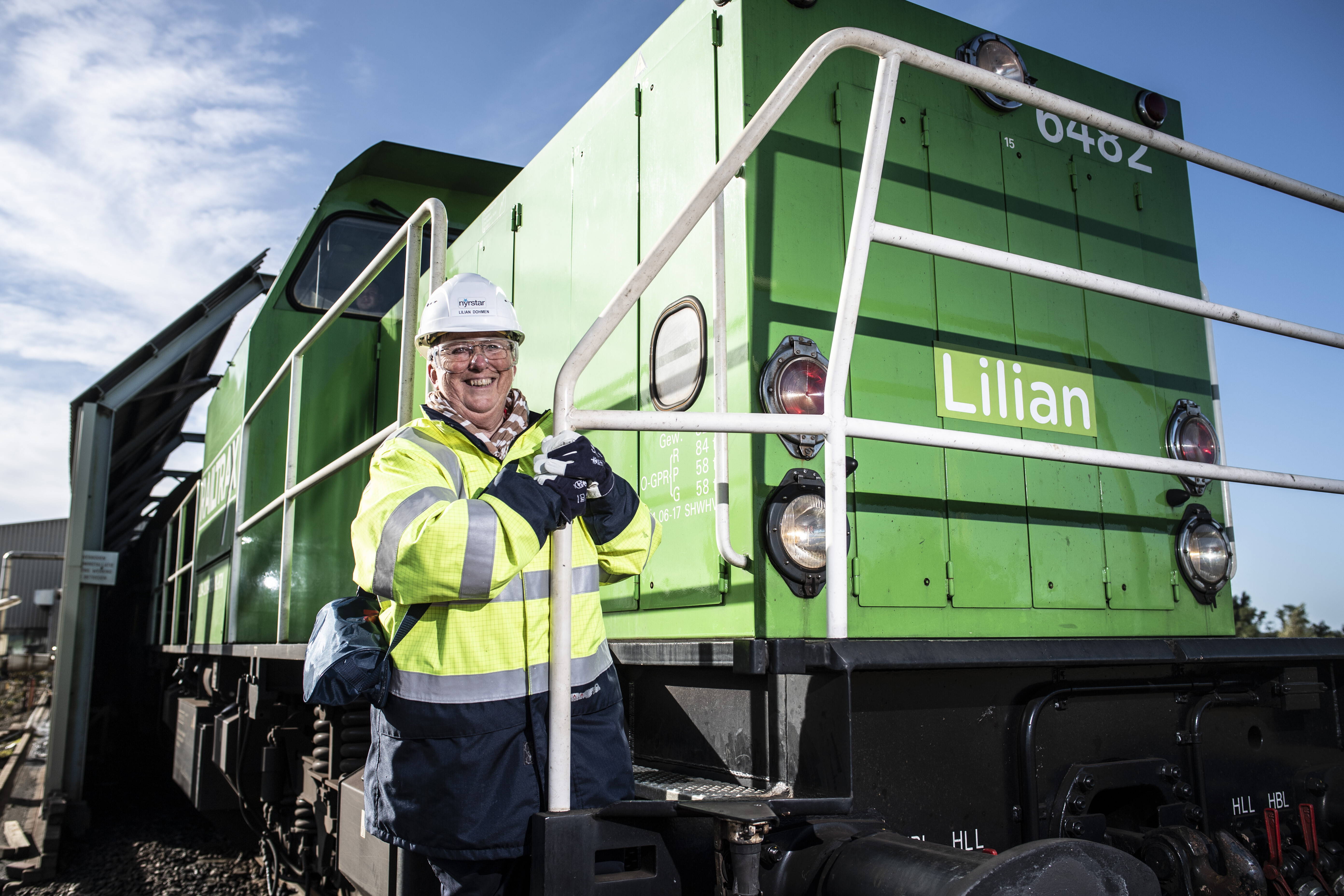 Lilian Dohmen, logistics coordinator at Nyrstar Budel, in front of her green locomotive.